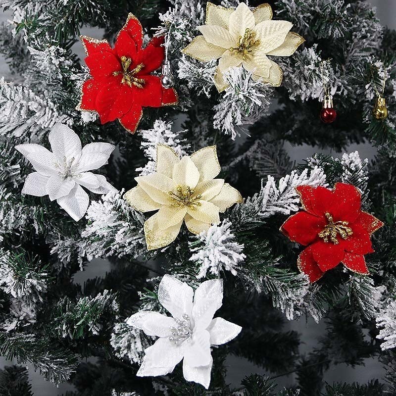 Flores decorativas vermelhas e douradas para o Natal